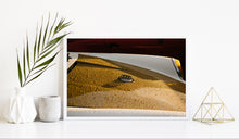 Load image into Gallery viewer, Framed image on white wall of gold and white Porsche 911 hood detail