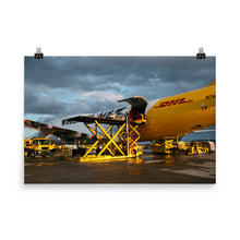 Load image into Gallery viewer, Porsche 992 loaded onto DHL Boeing 747 at dusk
