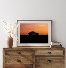 Load image into Gallery viewer, Framed image on white wall of Porsche 911 silhouette against orange sky
