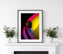 Load image into Gallery viewer, Framed picture of Porsche 911 headlight lit in pink and yellow 

